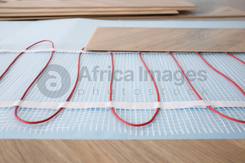 Installation of modern underfloor trace heating system indoors, closeup