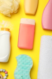 Photo of Flat lay composition with baby cosmetic products on yellow background