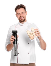 Smiling chef holding sous vide cooker and eggplant in vacuum pack on white background