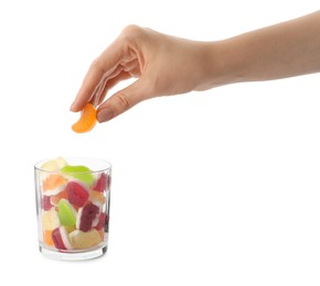Woman taking gummy candy from glass on white background, closeup