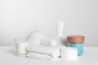 Photo of Spa composition with care products on white wooden table