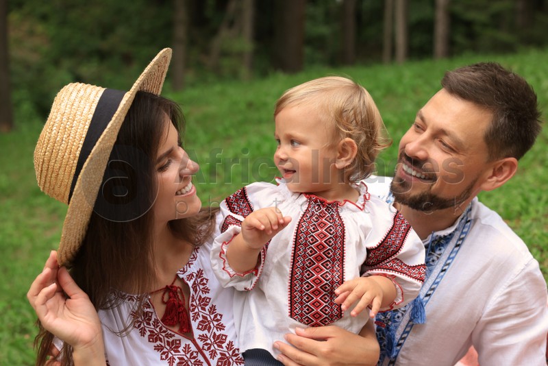 Happy family in Ukrainian national clothes outdoors