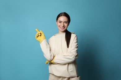 Beekeeper in uniform pointing at something on light blue background