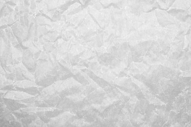 Texture of crumpled white baking paper as background, top view