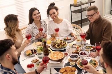 Group of people having brunch together at table indoors