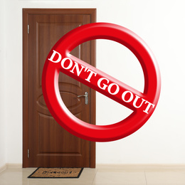 Closed door and sign DON'T GO OUT. Stay at home during coronavirus quarantine