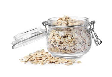Raw oatmeal and glass jar on white background