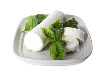 Delicious goat cheese with basil on white background