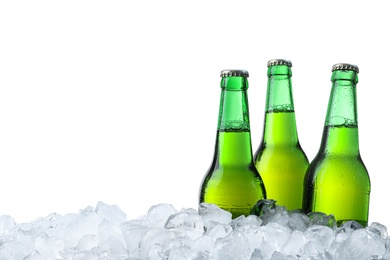 Photo of Bottles of beer on ice cubes against white background
