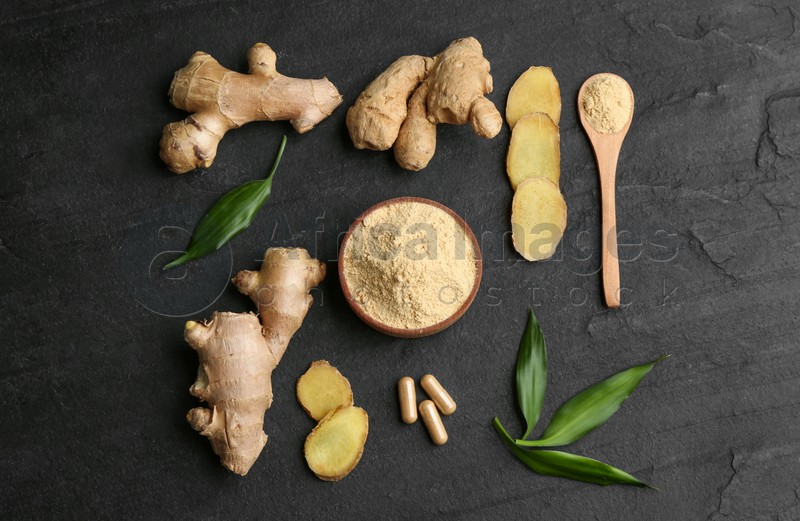 Photo of Flat lay composition with fresh and dry ginger on black slate table