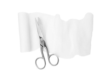 Medical bandage and scissors on white background, top view