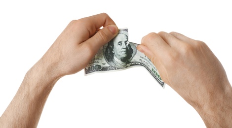 Man tearing dollar bill on white background, closeup