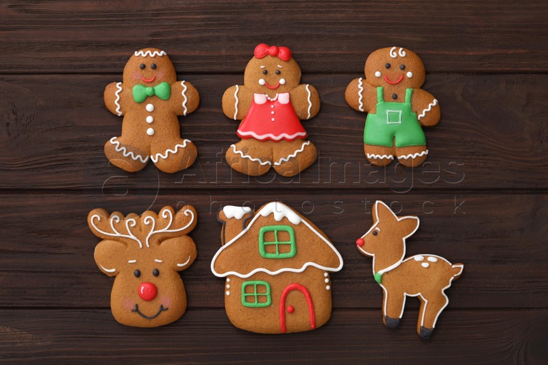 Different delicious Christmas cookies on wooden table, flat lay