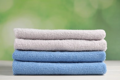 Soft folded towels on white wooden table