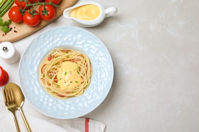 Delicious spaghetti with meat and cheese sauce served on light grey table, flat lay. Space for text