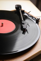 Modern vinyl record player with disc, closeup