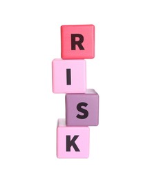 Woman stacking color wooden cubes with word Risk on white background, closeup
