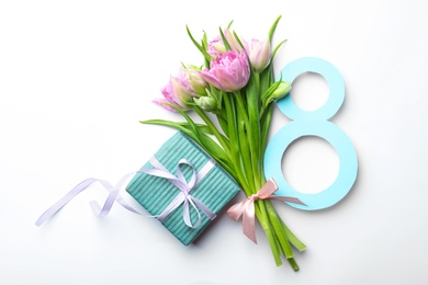 Photo of 8 March greeting card design with tulips and gift on white background, top view