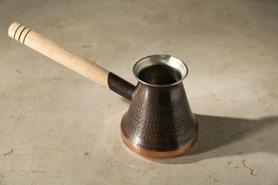 Beautiful copper turkish coffee pot on light table