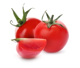 Whole and cut fresh tomatoes on white background