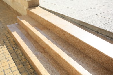 Photo of View of beige house stairs outdoors on sunny day