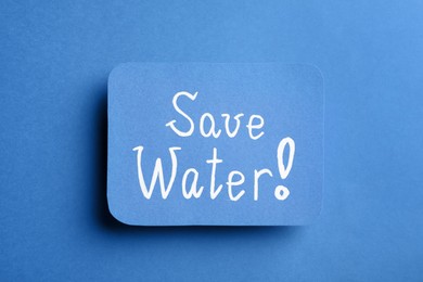 Photo of Card with words Save Water on blue background, top view