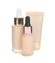 Bottles and tube with skin foundation on white background. Makeup products