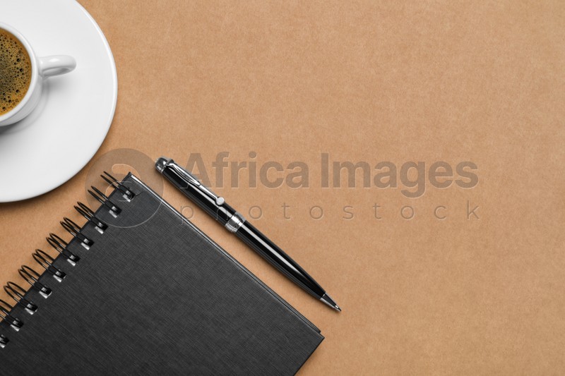 Flat lay composition with stylish notebook on brown background. Space for text