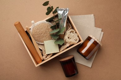 Wooden box with eco friendly products on craft paper, flat lay
