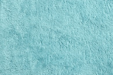 Soft light blue towel as background, top view