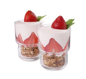 Glasses of tasty yogurt with muesli and strawberries isolated on white