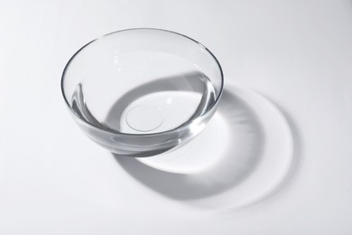 Photo of Glass bowl with water on white background