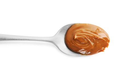Spoon with tasty boiled condensed milk isolated on white, top view