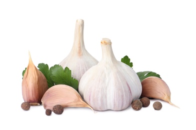 Fresh garlic bulbs and cloves with seasonings on white background. Organic food