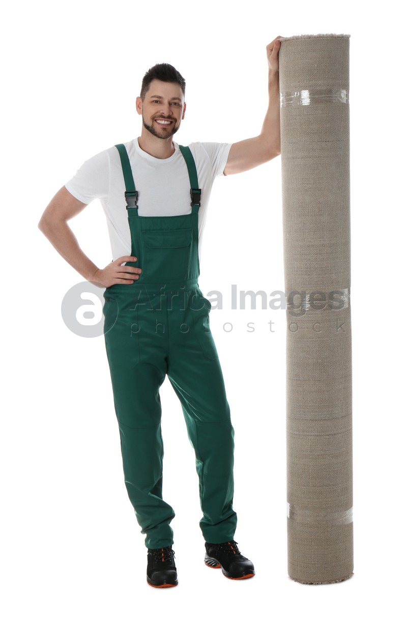 Photo of Male worker with rolled carpet on white background
