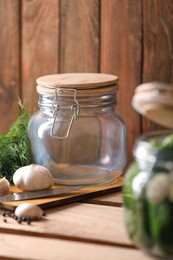 Empty glass jar on wooden table. Canning vegetable