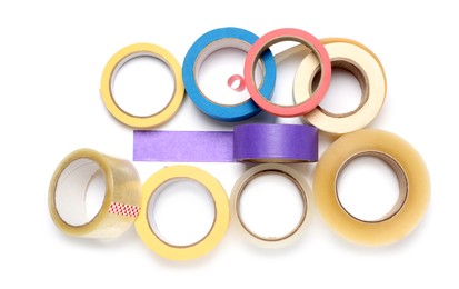 Many different rolls of adhesive tape on white background, top view