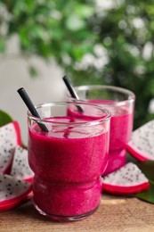 Delicious pitahaya smoothie and fresh fruits on wooden table