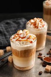 Glasses with delicious caramel frappe on tray