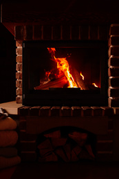 Fireplace with burning wood indoors. Winter vacation