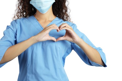 Photo of African-American doctor in protective mask making heart with hands on white background, closeup