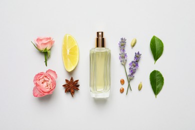 Photo of Flat lay composition with bottle of perfume, lemon and flowers on light grey background