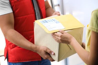 Woman receiving parcels from courier on doorstep, closeup