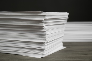 Stack of paper sheets on wooden table, closeup