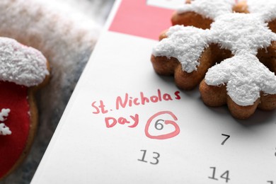 Saint Nicholas Day. Calendar with marked date December 06 and gingerbread cookies, closeup
