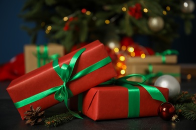 Beautiful gift boxes and Christmas decor on black table, closeup