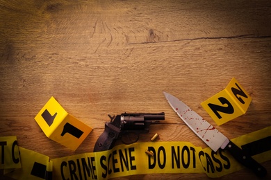Flat lay composition with evidences on wooden background, space for text. Crime scene