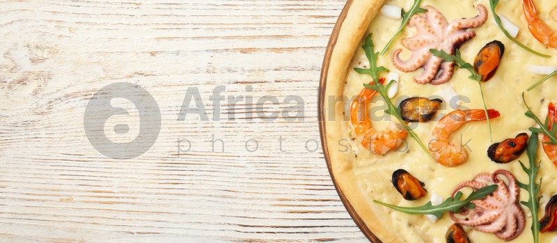 Image of Top view of hot delicious pizza on white wooden table, space for text. Banner design 