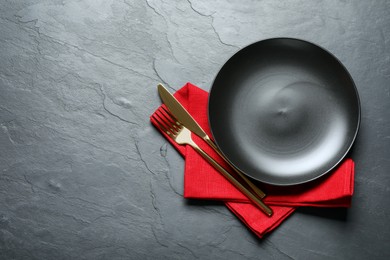 Photo of Beautiful table setting on black background, top view. Space for text