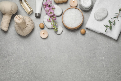 Flat lay composition with cosmetics on grey marble table, space for text. Spa treatment